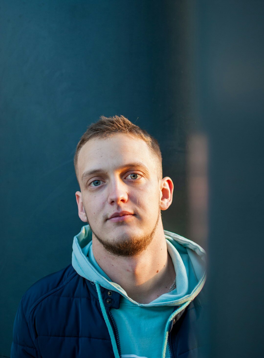 Studio portrait of a man with short hair outdoors