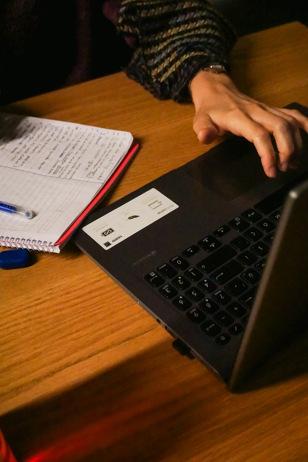 Close-up of hands typing a password on a laptop keyboard