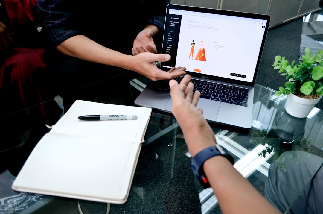 Team discussing data and statistics around a table with a laptop