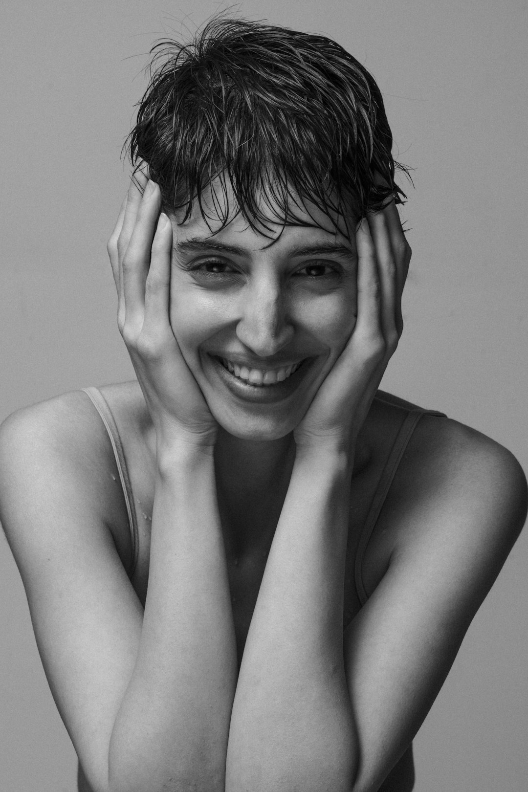 Studio portrait of a smiling woman with short hair