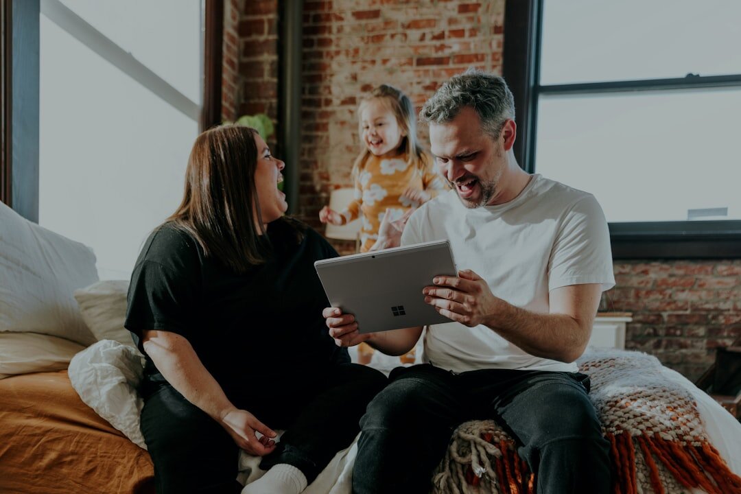 Parent and child looking together at a tablet screen at home